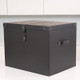 A black storage box with a lid and leather-like accents. The box is positioned on a white surface. A black storage box with a lid and leather-like accents. The box is positioned on a white surface.